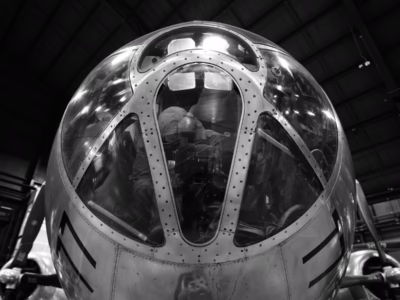 A bomb needs a delivery system, in this case a B-29 with its armor and almost all of its defensive guns removed. In this image we see a re-creation of the bombardier, now in control of the aircraft, working to aim the weapon at the target, despite the thick cloud cover. This B-29, named Bockscar, is the actual B-29 that dropped Fat Man on Nagasaki and is located at the National Museum of the US Air Force, in Dayton, Ohio.