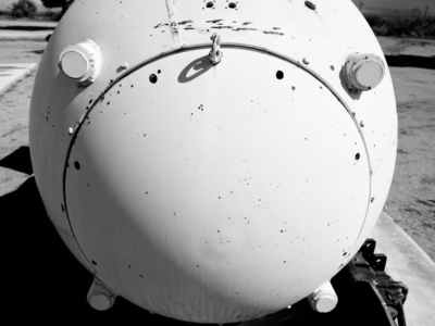 A white-painted Fat Man on display in the outdoor "rocket garden" at the White Sands Missile Range, in New Mexico. This particular unit is, twice every year, trucked out to the Trinity site for public viewing.
