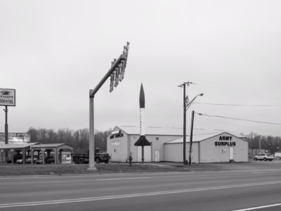 An Honest John posed outside of an Army-Navy Surplus store in Bedford, Indiana. Given the number of Honest John's on display in the United States I'm assuming that at some point a large number of them (rendered inert, of course) were sold as surplus.