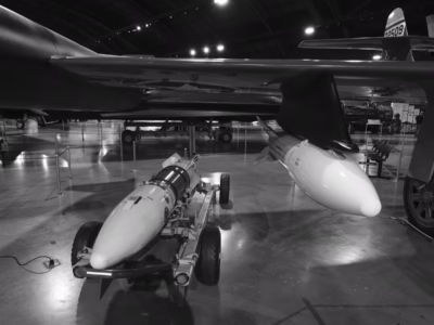 At first glance, Genie rockets can be confused with fuel tanks. In this image are two Genies, one attached to an aircraft and one still on its loading cart. Note the Genie on the left has a dark band across the middle which indicates it is a training unit. These rockets are at the National Museum of the US Air Force in Dayton.