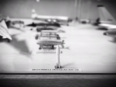 A tiny model Genie stands erect in front of an array of other nuclear weapons--a Nike-Hercules on the left, the Mark 7 Mark 43 bombs, and the Rascal missile behind it. Located at the Travis AFB Aviation Museum in Vacaville, California.